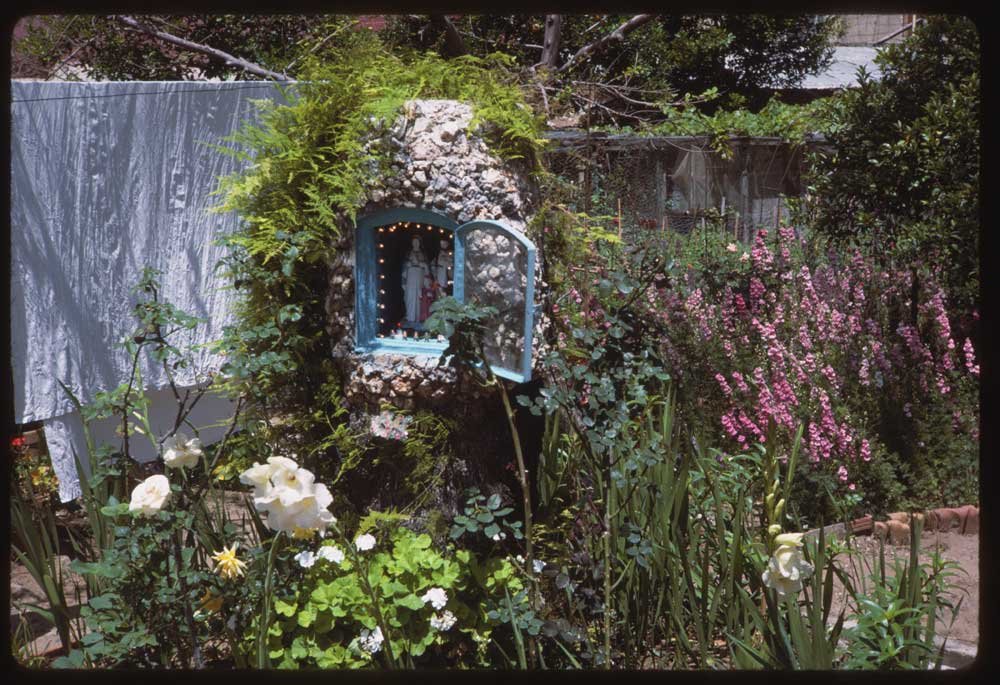 "A little shrine in a flower garden."
