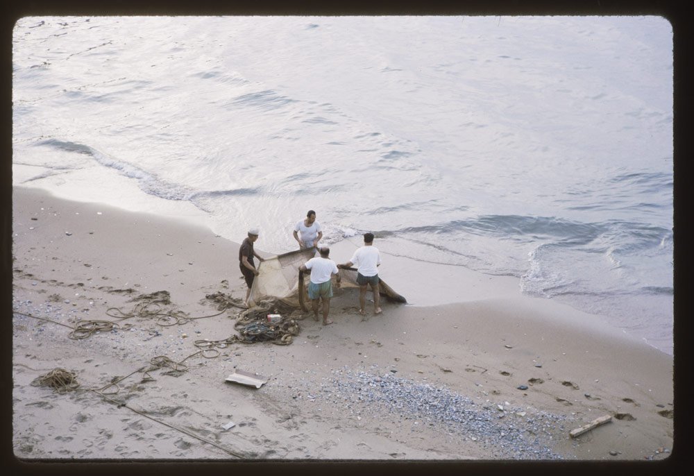 More fishermen fussed with a net.